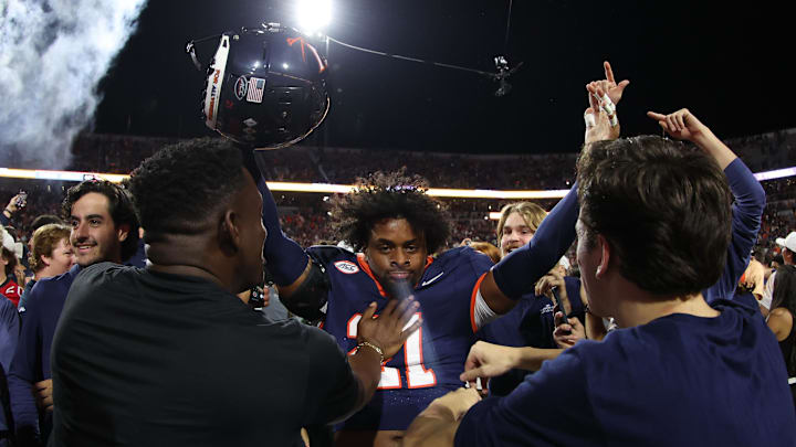 Sep 26, 2025; Charlottesville, Virginia, USA; Virginia Cavaliers safety Keke Adams (21) celebrates with fans on the field after the Cavaliers win over the Florida State Seminoles in two overtimes at Scott Stadium. Mandatory Credit: Geoff Burke-Imagn Images