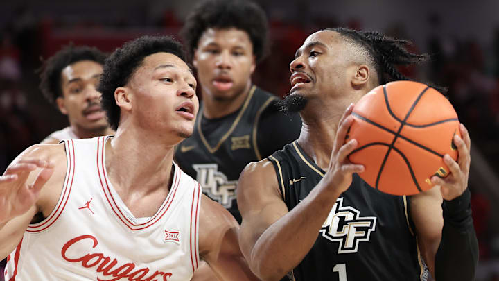 Feb 4, 2026; Houston, Texas, USA; UCF Knights guard Themus Fulks (1) drives against Houston Cougars guard Isiah Harwell (1) in the second half at Fertitta Center. Mandatory Credit: Thomas Shea-Imagn Images
