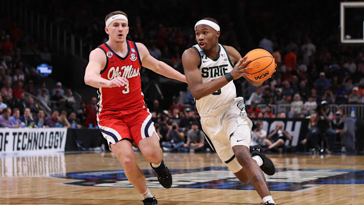 Mar 28, 2025; Atlanta, GA, USA; Michigan State Spartans guard Tre Holloman (5) drives against Mississippi Rebels guard Sean Pedulla (3) in the second half of a South Regional semifinal of the 2025 NCAA tournament at State Farm Arena. Mandatory Credit: Brett Davis-Imagn Images