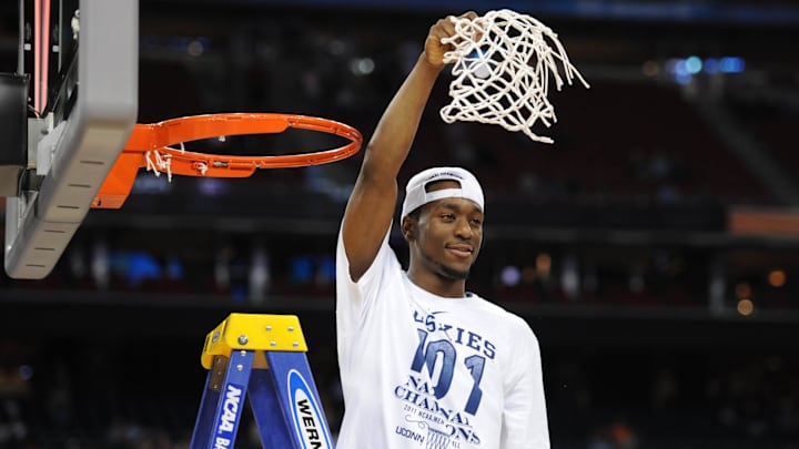 Apr 4, 2011; Houston, TX, USA; Connecticut Huskies guard Kemba Walker waves to the crowd after cutting down the net after the championship game of the Final Four of the 2011 NCAA men's college basketball tournament against the Butler Bulldogs at Reliant Stadium. Connecticut won 53-41. Mandatory Credit: Bob Donnan-Imagn Images