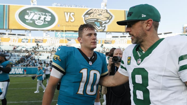 Dec 15, 2024; Jacksonville, Florida, USA; Jacksonville Jaguars quarterback Mac Jones (10) and New York Jets quarterback Aaron Rodgers (8) after the game at EverBank Stadium. Mandatory Credit: Morgan Tencza-Imagn Images