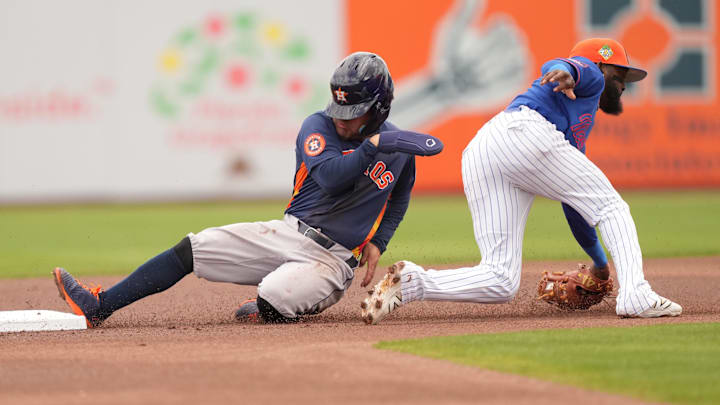 Altuve slides into base in a blue Astros jerse