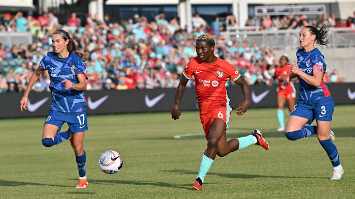 May 12, 2024; Kansas City, Missouri, USA; Kansas City Current forward Temwa Chawinga (6) dribbles as North Carolina Courage midfielder Dani Weatherholt (17) and defender Kaleigh Kurtz (3) defend during the second half at CPKC Stadium. Mandatory Credit: Peter Aiken-USA TODAY Sports
