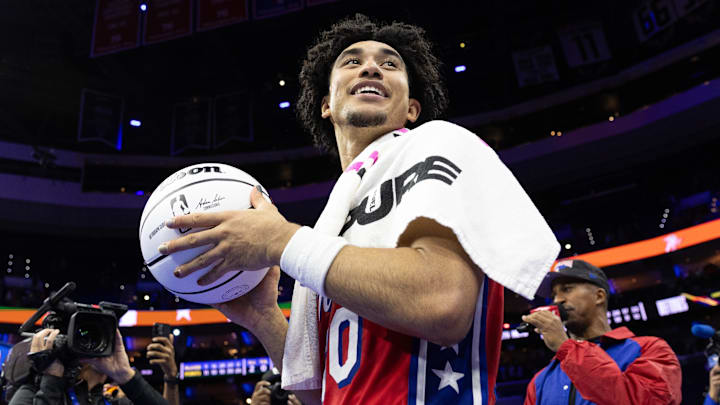 Nov 22, 2024; Philadelphia, Pennsylvania, USA; Philadelphia 76ers guard Jared McCain (20) prepares to throw a game ball to fans after a victory against the Brooklyn Nets at Wells Fargo Center. Mandatory Credit: Bill Streicher-Imagn Images
