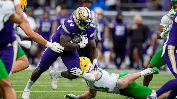 Washington running back Adam Mohammed carries the ball as the Oregon Ducks take on the Washington Huskies on Nov. 29, 2025, at Husky Stadium in Seattle, Washington. Washington running back Adam Mohammed carries the ball as the Oregon Ducks take on the Washington Huskies on Nov. 29, 2025, at Husky Stadium in Seattle, Washington.