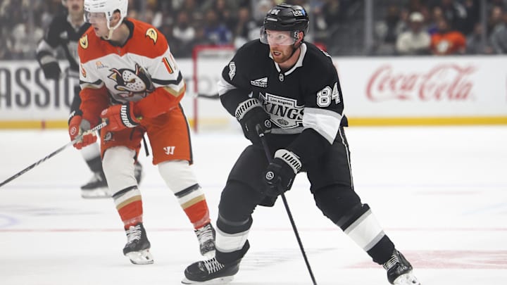 Feb 8, 2025; Los Angeles, California, USA; Los Angeles Kings defenseman Vladislav Gavrikov (84) skates with the puck against the Anaheim Ducks during the second period of a hockey game at Crypto.com Arena. Mandatory Credit: Jessica Alcheh-Imagn Images
