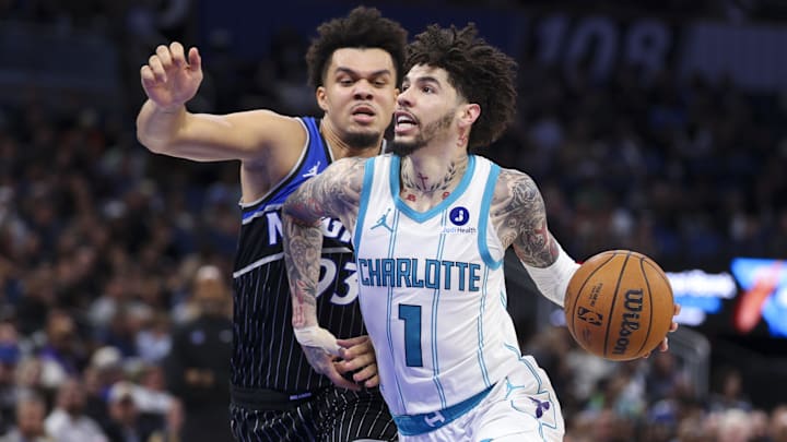 Jan 22, 2026; Orlando, Florida, USA; Charlotte Hornets guard LaMelo Ball (1) drives the ball past Orlando Magic forward Noah Penda (93) in the fourth quarter at Kia Center. Mandatory Credit: Nathan Ray Seebeck-Imagn Images
