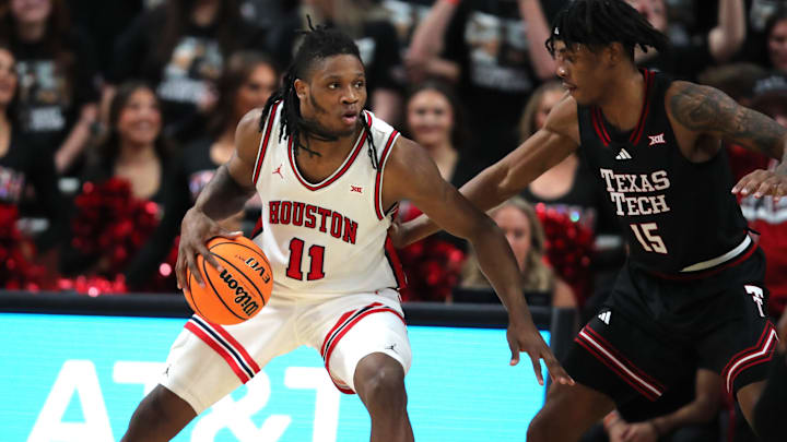Feb 24, 2025; Lubbock, Texas, USA;  Houston Cougars forward Joseph Tugler (11) works the ball in front of Texas Tech Red Raiders forward JT Toppin (15) in the second half at United Supermarkets Arena. Mandatory Credit: Michael C. Johnson-Imagn Images