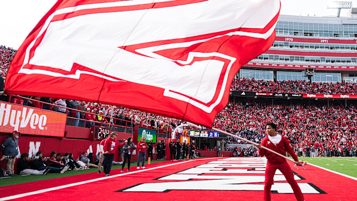 A cheerleader waves a school flag after the Huskers' go-ahead touchdown in the final three minutes against Northwestern. A cheerleader waves a school flag after the Huskers' go-ahead touchdown in the final three minutes against Northwestern.