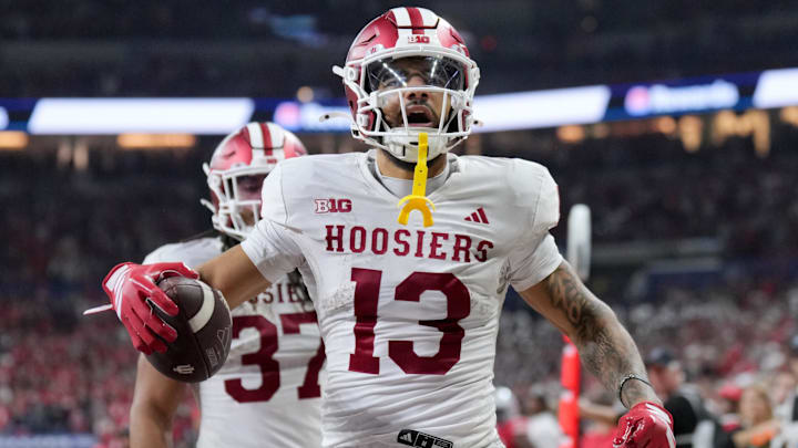 Dec 6, 2025; Indianapolis, IN, USA; Indiana Hoosiers wide receiver Elijah Sarratt (13) celebrates after scoring a touchdown against the Ohio State Buckeyes in the third quarter during the 2025 Big Ten championship game at Lucas Oil Stadium. Mandatory Credit: Aaron Doster-Imagn Images