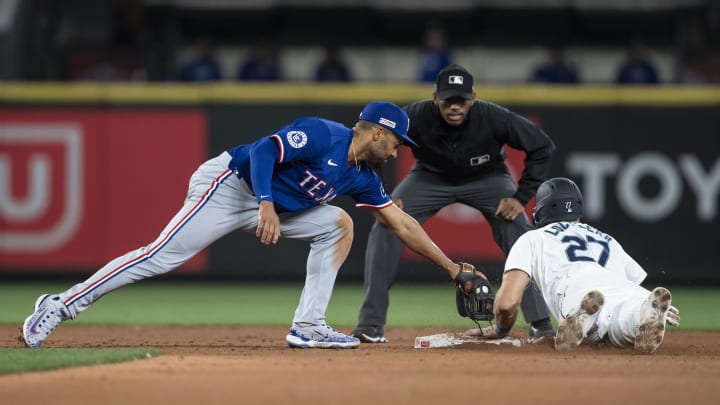 Jun 15, 2024; Seattle, Washington, USA; Seattle Mariners first baseman Tyler Locklear (20) steals second base ahead of a tag by Texas Rangers second baseman Marcus Semien (2) during the sixth inning at T-Mobile Park. Jun 15, 2024; Seattle, Washington, USA; Seattle Mariners first baseman Tyler Locklear (20) steals second base ahead of a tag by Texas Rangers second baseman Marcus Semien (2) during the sixth inning at T-Mobile Park.
