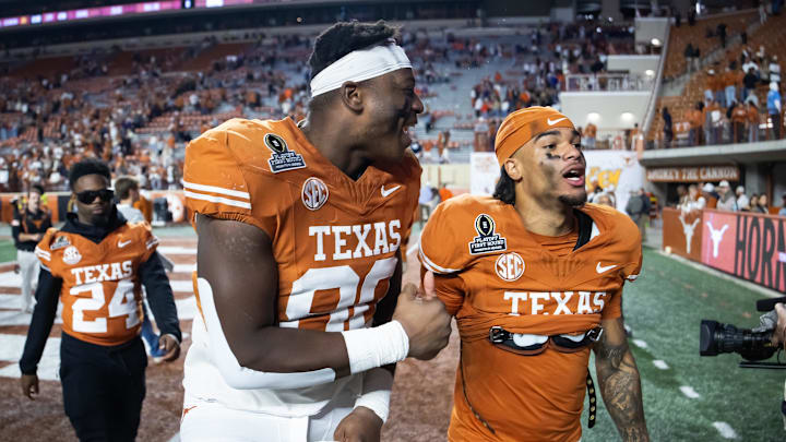 Dec 21, 2024; Austin, Texas, USA; Texas Longhorns offensive lineman Malik Agbo (80) celebrates with wide receiver DeAndre Moore Jr. (0) after defeating the Clemson Tigers during the CFP National playoff first round at Darrell K Royal-Texas Memorial Stadium. Mandatory Credit: Mark J. Rebilas-Imagn Images