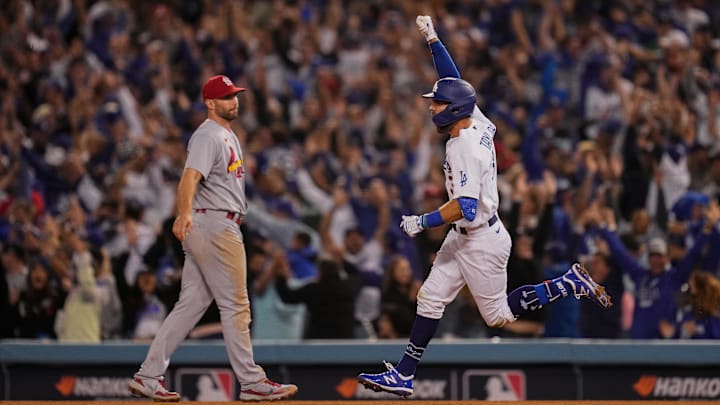 Oct 6, 2021; Los Angeles, California, USA; Los Angeles Dodgers left fielder Chris Taylor (3) raises his fist as he runs past St. Louis Cardinals first baseman Paul Goldschmidt (46) after hitting a 2-run walk-off home run in the National League Wild Card Game at Dodger Stadium. Mandatory Credit: Robert Hanashiro-Imagn Images