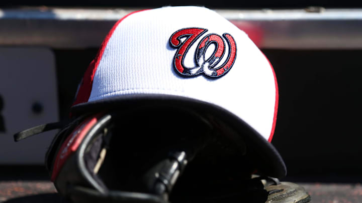 White Washington Nationals hat on top of a black mitt