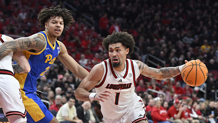 Mar 1, 2025; Louisville, Kentucky, USA;  Louisville Cardinals guard J'Vonne Hadley (1) dribbles past Pittsburgh Panthers forward Cameron Corhen (2) during the second half at KFC Yum! Center. Louisville defeated Pittsburgh 79-68. Mandatory Credit: Jamie Rhodes-Imagn Images