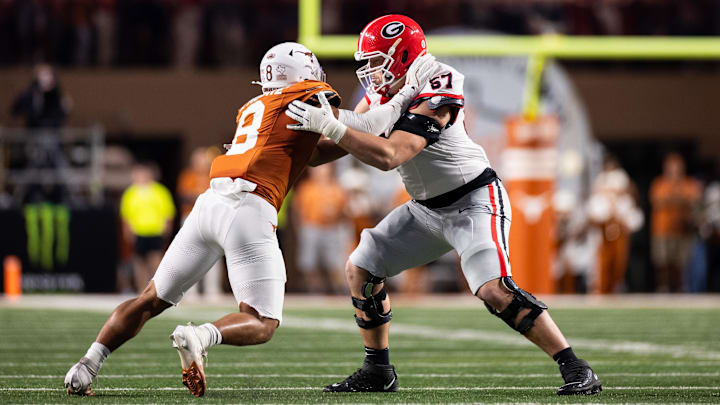 Oct 19, 2024; Austin, Texas, USA; Georgia Bulldogs offensive lineman Monroe Freeling (57) blocks Texas Longhorns edge rusher Trey Moore (8) in the second quarter at Darrell K Royal-Texas Memorial Stadium. Mandatory Credit: Brett Patzke-Imagn Images