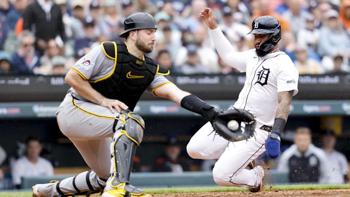 Jun 19, 2025; Detroit, Michigan, USA;  Detroit Tigers second baseman Gleyber Torres (25) slides in safe at home ahead of the tag by Pittsburgh Pireates catcher Joey Bart in the fourth inning at Comerica Park. Mandatory Credit: Rick Osentoski-Imagn Images