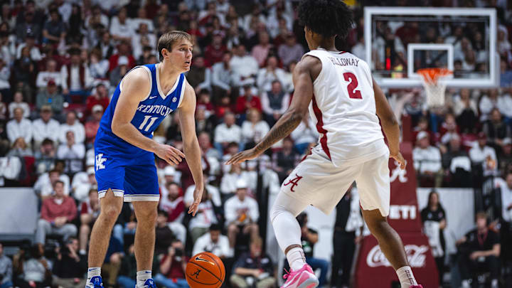 Feb 22, 2025; Tuscaloosa, Alabama, USA; Kentucky Wildcats guard Travis Perry (11) looks for a pas against Alabama Crimson Tide guard Aden Holloway (2) during the second half at Coleman Coliseum. Mandatory Credit: Will McLelland-Imagn Images