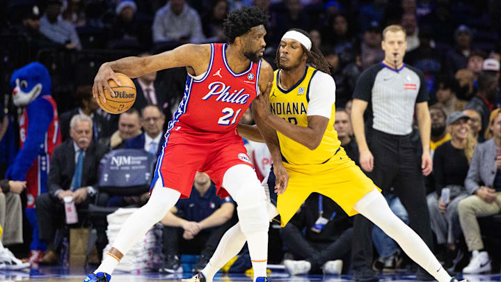 Dec 13, 2024; Philadelphia, Pennsylvania, USA; Philadelphia 76ers center Joel Embiid (21) controls the ball against Indiana Pacers center Myles Turner (33) during the first quarter at Wells Fargo Center. Mandatory Credit: Bill Streicher-Imagn Images