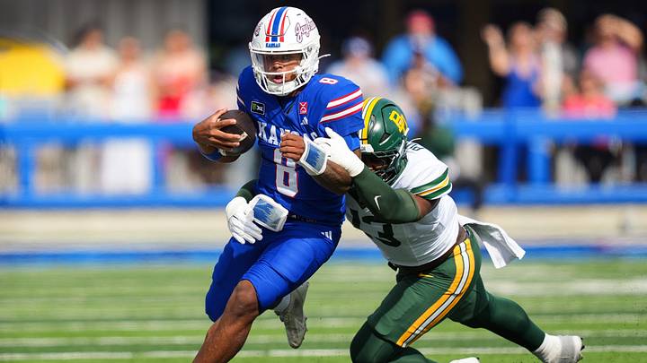 Oct 24, 2026; Lawrence, Kansas, USA; Kansas Jayhawks quarterback Isaiah Marshall (8) runs the ball against Baylor Bears defensive end Garrick Ponder (13) during the first half at David Booth Kansas Memorial Stadium. Mandatory Credit: Jay Biggerstaff-Imagn Images