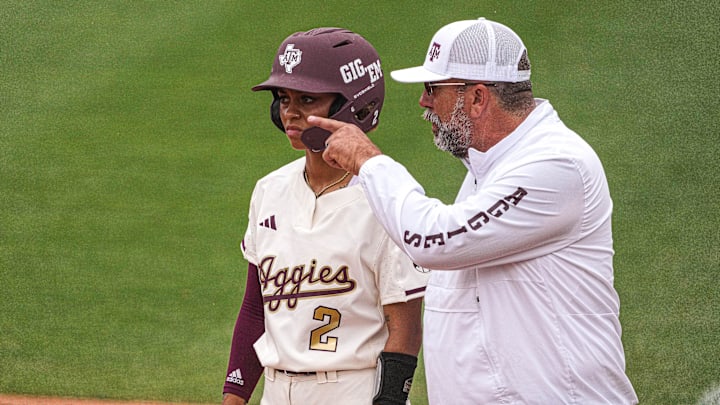 Texas A&M coach Ress Heffley give infielder Rylen Wiggins (2) instructions at first base during the NCAA Regional game against the Texas Longhorns at Red Charline McCombs Field on Sunday, May 21, 2023 in Austin.
