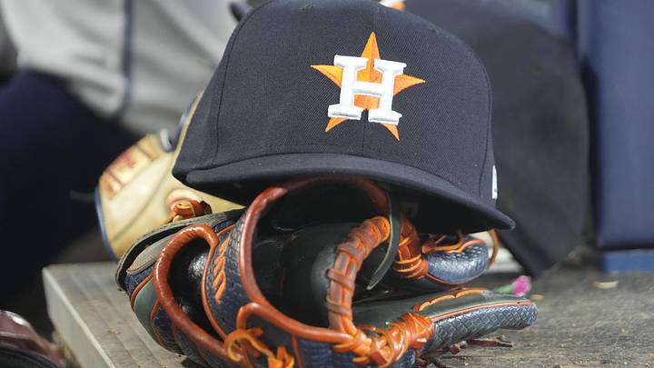 A Houston Astros hat and ball glove.
