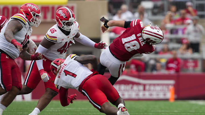Sep 20, 2025; Madison, Wisconsin, USA; Wisconsin Badgers quarterback Danny O'Neil (18) is tackled by Maryland Terrapins linebacker Daniel Wingate (1) during the third quarter at Camp Randall Stadium. Mandatory Credit: Jeff Hanisch-Imagn Images Sep 20, 2025; Madison, Wisconsin, USA; Wisconsin Badgers quarterback Danny O'Neil (18) is tackled by Maryland Terrapins linebacker Daniel Wingate (1) during the third quarter at Camp Randall Stadium. Mandatory Credit: Jeff Hanisch-Imagn Images