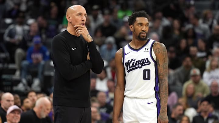 Dec 30, 2024; Sacramento, California, USA; Sacramento Kings interim head coach Doug Christie (left) talks with guard Malik Monk (0) during the second quarter against the Dallas Mavericks at Golden 1 Center. Mandatory Credit: Darren Yamashita-Imagn Images