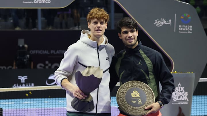 Jannik Sinner of Italy and Carlos Alcaraz of Spain pose for photos during the awarding ceremony for the final match at Saudi Arabia's 6 Kings Slam exhibition tennis tournament. Jannik Sinner of Italy and Carlos Alcaraz of Spain pose for photos during the awarding ceremony for the final match at Saudi Arabia's 6 Kings Slam exhibition tennis tournament.