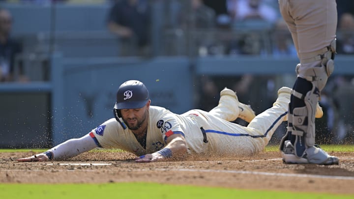 May 31, 2025; Los Angeles, California, USA; Los Angeles Dodgers left fielder Michael Conforto (23) slides to score in the second inning against the New York Yankees at Dodger Stadium. Mandatory Credit: Jayne Kamin-Oncea-Imagn Images