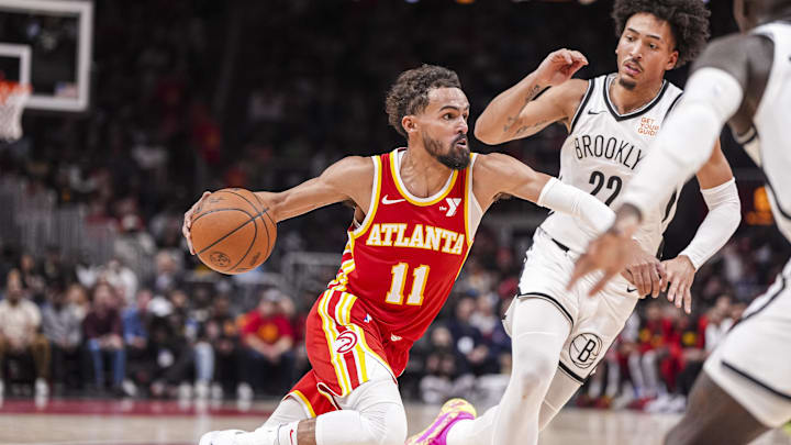 Oct 23, 2024; Atlanta, Georgia, USA; Atlanta Hawks guard Trae Young (11) dribbles against Brooklyn Nets forward Jalen Wilson (22) during the second half at State Farm Arena. Mandatory Credit: Dale Zanine-Imagn Images