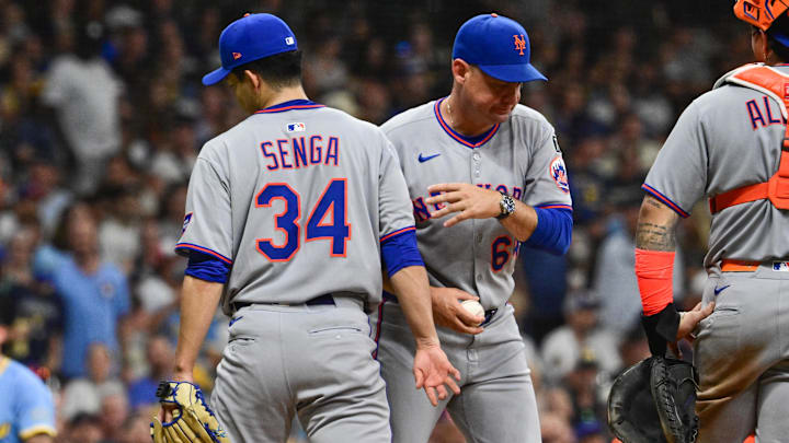 Aug 8, 2025; Milwaukee, Wisconsin, USA; New York Mets manager Carlos Mendoza takes the ball from starting pitcher Kodai Senga (34) during a pitching change in the fifth inning against the Milwaukee Brewers at American Family Field. Mandatory Credit: Benny Sieu-Imagn Images Aug 8, 2025; Milwaukee, Wisconsin, USA; New York Mets manager Carlos Mendoza takes the ball from starting pitcher Kodai Senga (34) during a pitching change in the fifth inning against the Milwaukee Brewers at American Family Field. Mandatory Credit: Benny Sieu-Imagn Images
