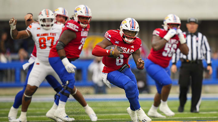 Nov 1, 2025; Lawrence, Kansas, USA; Kansas Jayhawks quarterback Jalon Daniels (6) runs the ball during the first half against the Oklahoma State Cowboys at David Booth Kansas Memorial Stadium. Mandatory Credit: Jay Biggerstaff-Imagn Images