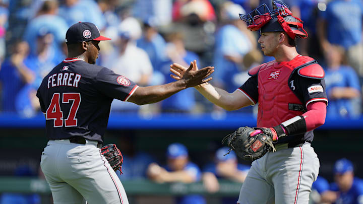 Aug 13, 2025; Kansas City, Missouri, USA; Washington Nationals relief pitcher Jose Ferrer (47) and catcher Drew Millas (81) celebrate after defeating the Kansas City Royals at Kauffman Stadium. 