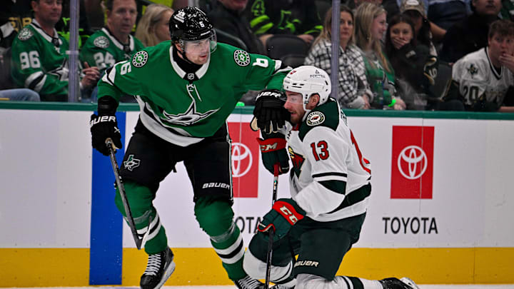 Oct 14, 2025; Dallas, Texas, USA; Dallas Stars defenseman Lian Bichsel (6) checks Minnesota Wild center Yakov Trenin (13) during the first period at the American Airlines Center. Mandatory Credit: Jerome Miron-Imagn Images