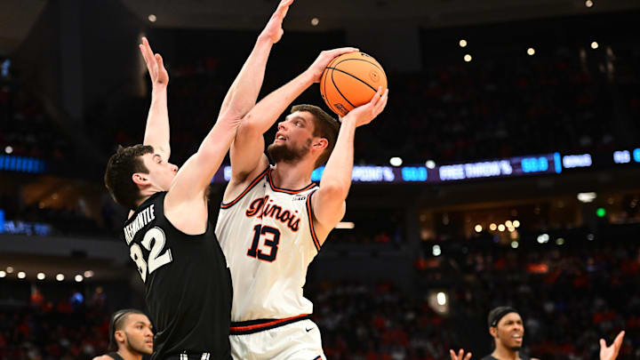 Mar 21, 2025; Milwaukee, WI, USA: Illinois Fighting Illini center Tomislav Ivisic (13) drives to the hoop past Xavier Musketeers forward Zach Freemantle (32) during the second half at Fiserv Forum. Mandatory Credit: Benny Sieu-Imagn Images Mar 21, 2025; Milwaukee, WI, USA: Illinois Fighting Illini center Tomislav Ivisic (13) drives to the hoop past Xavier Musketeers forward Zach Freemantle (32) during the second half at Fiserv Forum. Mandatory Credit: Benny Sieu-Imagn Images