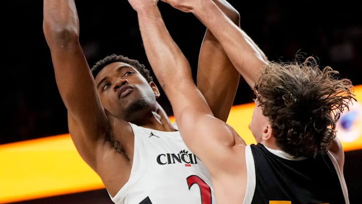 Cincinnati Bearcats forward Dillon Mitchell (23) dries against Arkansas-Pine Bluff Golden Lions guard Raphael Dumont (13) in the first half of the NCAA mens basketball game between the Cincinnati Bearcats and the Arkansas-Pine Bluff Golden Lions at Fifth Third Arena on the University of Cincinnati campus on Monday, Nov. 4, 2024. The Bearcats led 55-32 at halftime. Cincinnati Bearcats forward Dillon Mitchell (23) dries against Arkansas-Pine Bluff Golden Lions guard Raphael Dumont (13) in the first half of the NCAA mens basketball game between the Cincinnati Bearcats and the Arkansas-Pine Bluff Golden Lions at Fifth Third Arena on the University of Cincinnati campus on Monday, Nov. 4, 2024. The Bearcats led 55-32 at halftime.