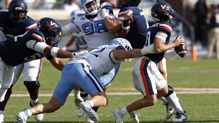 Oct 26, 2024; Charlottesville, Virginia, USA; Virginia Cavaliers quarterback Anthony Colandrea (10) is sacked by North Carolina Tar Heels defensive lineman Beau Atkinson (12) during the second half at Scott Stadium. Mandatory Credit: Geoff Burke-Imagn Images Oct 26, 2024; Charlottesville, Virginia, USA; Virginia Cavaliers quarterback Anthony Colandrea (10) is sacked by North Carolina Tar Heels defensive lineman Beau Atkinson (12) during the second half at Scott Stadium. Mandatory Credit: Geoff Burke-Imagn Images