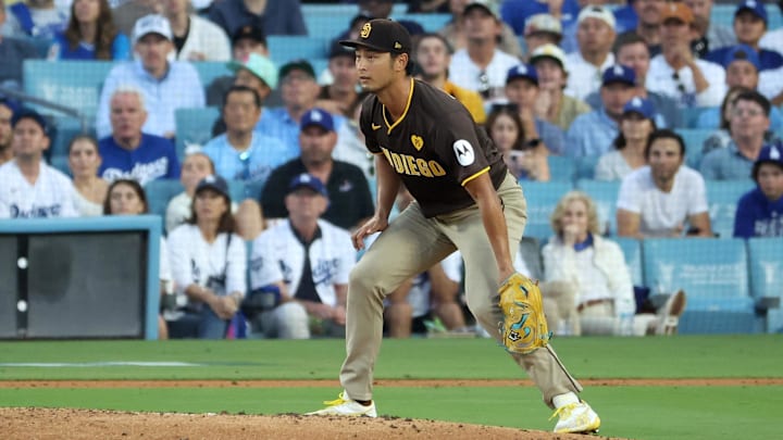Oct 6, 2024; Los Angeles, California, USA; San Diego Padres pitcher Yu Darvish (11) watches a play against the Los Angeles Dodgers in the fourth inning during game two of the NLDS for the 2024 MLB Playoffs at Dodger Stadium. Mandatory Credit: Kiyoshi Mio-Imagn Images