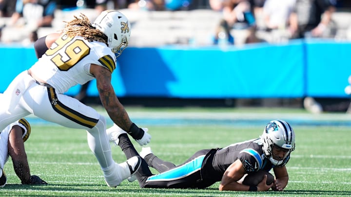 Nov 9, 2025; Charlotte, North Carolina, USA;  Carolina Panthers quarterback Bryce Young (9) is sacked as New Orleans Saints defensive end Chase Young (99) defends during the second quarter at Bank of America Stadium. Mandatory Credit: Jim Dedmon-Imagn Images