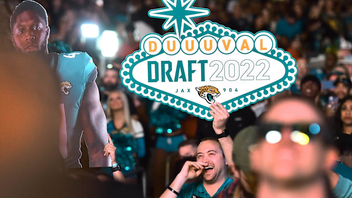 A Jaguars fan in the crowd holds a DUUUVAL Draft sign during the team's NFL Draft party Thursday