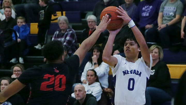 Nevada guard Jacob Khounsourath (0) takes a three-point shot over Roland-Story Jonovan Wilkinson (20) during the fourth quarter at Nevada High school gym on Friday, Feb. 2, 2024, in Nevada, Iowa.