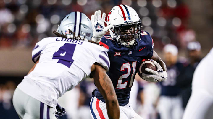 Sep 12, 2025; Tucson, Arizona, USA; Arizona Wildcats running back Ismail Mahdi (21) runs the ball while Kansas State Wildcats safety Daniel Cobbs (4) defends during the fourth quarter at Arizona Stadium. Mandatory Credit: Aryanna Frank-Imagn Images