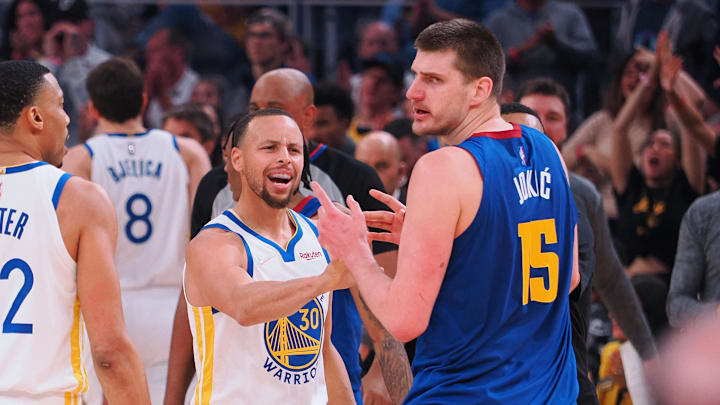 Apr 18, 2022; San Francisco, California, USA; Golden State Warriors guard Stephen Curry (30) and Denver Nuggets center Nikola Jokic (15) in a confrontation as a time out is called during the first quarter of game two of the first round for the 2022 NBA playoffs at Chase Center. Mandatory Credit: Kelley L Cox-Imagn Images Apr 18, 2022; San Francisco, California, USA; Golden State Warriors guard Stephen Curry (30) and Denver Nuggets center Nikola Jokic (15) in a confrontation as a time out is called during the first quarter of game two of the first round for the 2022 NBA playoffs at Chase Center. Mandatory Credit: Kelley L Cox-Imagn Images