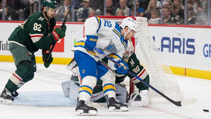Oct 15, 2026; Saint Paul, Minnesota, USA;  St. Louis Blues center Pius Suter (22) is blocked by Minnesota Wild goaltender Jesper Wallstedt (30) in the third period at Grand Casino Arena.  Mandatory Credit: Matt Blewett-Imagn Images