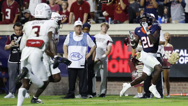 Sep 26, 2025; Charlottesville, Virginia, USA; Virginia Cavaliers running back Xavier Brown (20) catches a touchdown pass as Florida State Seminoles defensive back Edwin Joseph (3) looks on at Scott Stadium. Mandatory Credit: Geoff Burke-Imagn Images Sep 26, 2025; Charlottesville, Virginia, USA; Virginia Cavaliers running back Xavier Brown (20) catches a touchdown pass as Florida State Seminoles defensive back Edwin Joseph (3) looks on at Scott Stadium. Mandatory Credit: Geoff Burke-Imagn Images