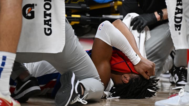 Detroit Pistons guard Jaden Ivey (23) grabs his leg as he falls to the court after being injured against the Orlando Magic in the fourth quarter at Little Caesars Arena.