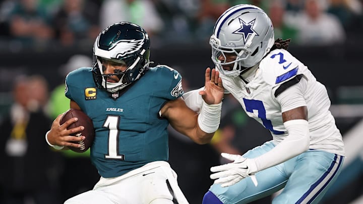 Dallas Cowboys cornerback Trevon Diggs tackles Philadelphia Eagles quarterback Jalen Hurts.