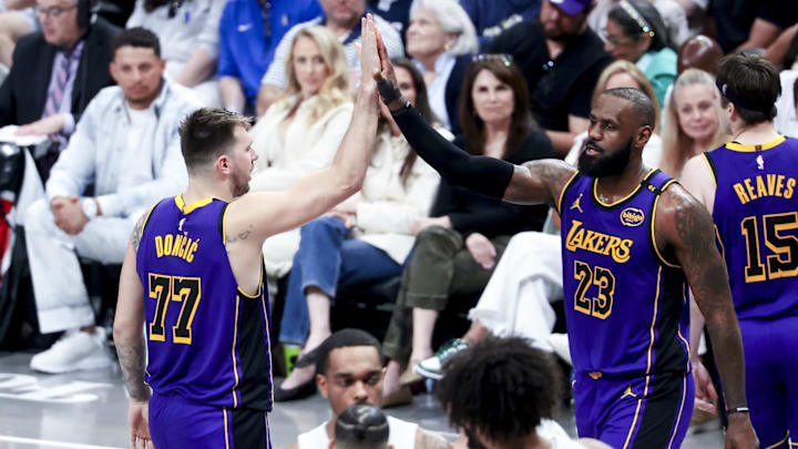 Apr 9, 2025; Dallas, Texas, USA;  Los Angeles Lakers guard Luka Doncic (77) celebrates with Los Angeles Lakers forward LeBron James (23) during the fourth quarter against the Dallas Mavericks at American Airlines Center. Mandatory Credit: Kevin Jairaj-Imagn Images