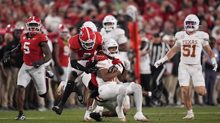 Nov 15, 2025; Athens, Georgia, USA; Georgia Bulldogs defensive back Kj Bolden (4) tackles Texas Longhorns wide receiver Ryan Niblett (21) in the first half at Sanford Stadium. Mandatory Credit: Dale Zanine-Imagn Images